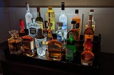 many different types of alcohol bottles on a table