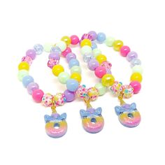 These adorable stretchy bracelets are the perfect favor for your little one's unicorn donut themed party! Each bracelet features a glittery rainbow unicorn donut charm, resin rhinestone beads and an assortment of pink, purple, blue, green and yellow 10mm acrylic beads strung with durable stretch floss cord. Each bracelet will arrive individually packaged in organza bags. Select the size and number of bracelets needed from the drop down menus. Please message me if you have any questions or if you Donut Themed Party, Unicorn Donut, Girl Rainbow, Pink Purple Blue, Rainbow Birthday, Stretchy Bracelets, Comfy Sweaters, Rhinestone Bead, Rainbow Unicorn