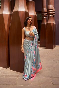 Elevate your saree collection with our Light Grey Digital Floral Printed Satin Crepe Saree. The subtle gray hue and delicate floral print exude elegance and sophistication. Made from soft and flowing satin crepe, this saree promises to drape beautifully for any occasion. The running pallu adds a touch of grace, while the plain blouse completes the luxurious look. Experience comfort and style with this party wear saree. Material: Satin Crepe Length:5.5 meter ( Regular Saree length) Color: Light Grey color Blouse Piece Length: 1 meter ( Un- Stitched) Blouse Piece Description: Plain Blouse Piece. Washing Instructions: Light Wash only. Goddess Katyayani, Grey Saree, Floral Saree, Crepe Saree, Indian Sarees Online, Satin Saree, Party Kleidung, Trendy Sarees, Wear Saree