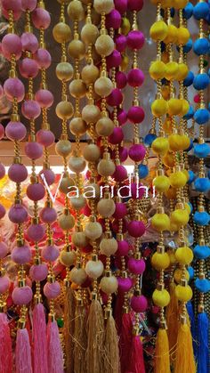 many different colored tassels hanging from the ceiling