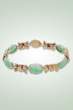 Adorn your wrist with sophistication! This Vintage 14K Yellow Gold Green Jade Bracelet features intricately carved oval cabochons, creating a timeless and unique piece. Embrace elegance with this vintage treasure. #JadeBracelet #CarvedJewelry #VintageGold Green Jade Bracelet, Ruby Emerald, Jade Bracelet, Tennis Bracelet Diamond, Seed Pearl, Hinged Bangle, Bracelet Collection, Green Jade, Pendant Bracelet