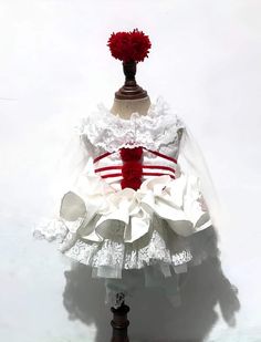 a mannequin dressed in white and red with a dress on top of it