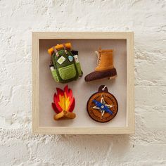 a shadow box with four different items in it