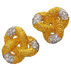 A striking pair of vintage gold and diamond earrings by Cartier c.1960s, each designed as a triple lobed knot in heavily textured 18ct yellow gold the central segment of each is pave set with round brilliant cut diamonds, all to clip fittings. Quintessentially 1960s in style these wonderfully bold earrings create real impact with their sculptural form and volume, textural variation and sparkling diamonds. Maker Cartier Period Circa 1960s Origin French made for export Gemstones 66 x round brilliant cut diamonds estimated to weigh a combined total of approximately 4.8cts Setting 18ct yellow gold signed Cartier Inc., Made In France 18k, with French export marks Weight 33 grams Dimensions 2.9cm/ 1.14" diameter Condition Very fine Gold And Diamond Earrings, Vintage Gold Earrings, Gold Snowflake, Ear Clips, Bold Earrings, Gold Sign, Diamond Ring Settings, Knot Earrings, Sparkle Diamonds