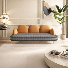 a living room filled with furniture next to a white table and wall mounted planter