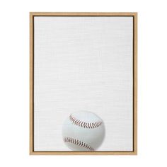 a baseball sitting in front of a white wall with a wooden frame on the side