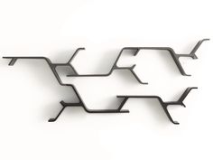 three metal objects are arranged in the shape of an abstract structure on a white background