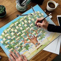 a person is painting a tree on a piece of paper with watercolor pencils