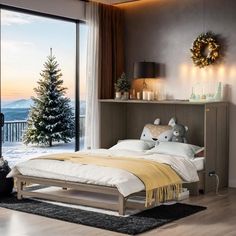 a bedroom with a large window overlooking the snow covered mountains and trees is pictured in this image