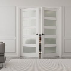 an open door in a white room with chairs