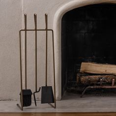 a fireplace with a fire in it next to a potted plant and shovels