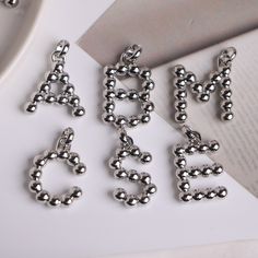 -------Silver plated Alphabet Letter Pendant, Elegant Round Beaded Fashion Pendant, Necklace Jewelry Accessories   Material: Metal Copper, Silver Plated Color: Gold color Size: Approx. 30mm in length Quantity: 10 Pieces / 26 Pieces Pendant Shape: A-Z Letter   Conversion : 1 inch = 25.4mm or 1mm = 0.0393 inch More style electroplating Micro Pave zircon beads & pendants charms, please view the BELOW listing: https://www.etsy.com/shop/Albertbeads?ref=listing-shop2-all-items-count&section_id=21546235 Welcome to our store! https://www.etsy.com/shop/Albertbeads Nickel-free Silver Initial Pendant Charms, Silver Nickel-free Initial Pendant Charms, Personalized Silver Necklaces With Round Beads, Silver Necklaces With Personalized Round Beads, Personalized Silver Metal Charms, Silver Letter Beads Charms For Gifts, Silver Sterling Silver Necklace With Letter Beads, Silver Round Pendant Charms, Silver Metal Round Pendant Charm