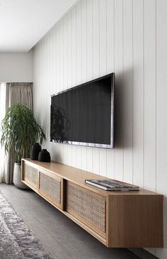 a flat screen tv mounted to the side of a wall