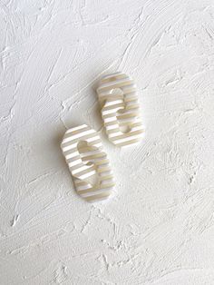 two white combs sitting on top of each other