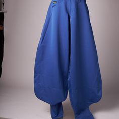 The Pants Are In Deadstock Condition With Tags Still Attached. Royal Shade Of Blue. There Are 2 Hip Pockets, A Small Front Pocket, 2 Button Back Pockets And Side Utility Pocket. Zipper At The Ankles Which Allows The Pants To Hang Over And Give A Wide Baggy Look. Measures 38 Cm Across Waist, 30 Cm Rise, 114 Cm Inseam Baggy Blue Cotton Pants, Blue Wide Leg Cargo Pants With Five Pockets, Blue Cotton Wide Leg Pants With Five Pockets, Baggy Blue Cotton Wide Leg Pants, Blue Baggy Cotton Wide Leg Pants, Blue Baggy Wide Leg Pants, Blue Full-length Parachute Pants For Streetwear, Blue Cotton Wide-leg Pants, Fitted Blue Pants For Streetwear