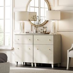 a white dresser sitting next to a window with a mirror on it's side