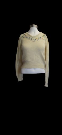 "soft warm and adorable made of a ivory knit that is super cute. the collar has a slight v neck style that is adorned with darling pastel rose embellishments and embroidery through out. The tag reads a size small and has some stretch to the material since it is a knit. just stunning and in excellent vintage condition. ** for international shipping please contact us prior to purchase :) ** The measurements are as follows and are taken lying flat and unstretched. shoulder to shoulder 15'' bust 34\ Fitted Soft Knit Sweater For Spring, Fitted Crew Neck Sweater In Cute Style, Fitted Cute Crew Neck Sweater, Fitted Beige Sweater For Spring, Cute Fitted Crew Neck Sweater, Cream Cozy Sweater For Spring, Cozy Cream Sweater For Spring, Vintage Cream Sweater For Spring, Vintage Cream Knit Tops