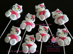 hello kitty cupcakes are on top of toothpicks