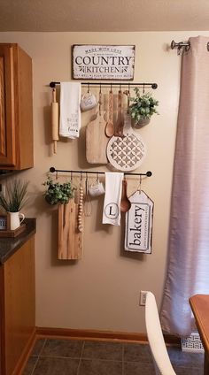 a kitchen with wooden utensils hanging on the wall