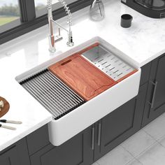 a kitchen sink with a wooden cutting board in it