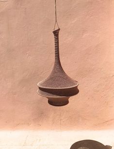 a bird feeder hanging from the side of a building