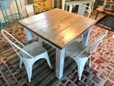 a wooden table and chairs sitting on top of a carpeted floor in a room