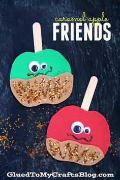 two popsicles with googly eyes and glitter on them