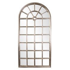 an arched window mirror on a white wall