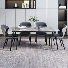 a dining room table with chairs and a bookcase in the back wall behind it