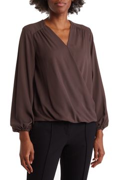 A long-sleeve blouse offers contemporary style with a gracefully draped faux-wrap silhouette and curved high-low hem. Surplice V-neck Long sleeves Draped wrap front Lightweight woven construction High-low hem 100% polyester Machine wash, tumble dry Imported Model stats: 5'10" height, 32" bust, 25" waist, 36" hip. Model is wearing size S. Texas Style, High Low Hem, Wrap Blouse, Contemporary Style, Long Sleeve Blouse, Nordstrom, Long Sleeve, Women's Top, How To Wear