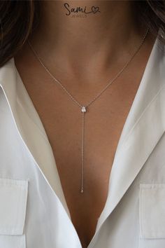 A pin of a silver pear lariat necklace. Formal Backdrop Necklace With Clavicle Chain, Elegant Y-shape Lariat Necklace With Clavicle Chain, Dainty White Gold Dangle Necklaces, Minimalist Delicate Chain Lariat Necklace For Formal Events, Fine Jewelry Lariat Drop Necklace With Delicate Chain, Chic Silver Lariat Necklace With Delicate Chain, Elegant Y-shape Clavicle Chain Necklace, Elegant Long Drop Necklace, Elegant Y-shaped Clavicle Chain Necklace