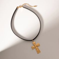 This black cord choker necklace with a cross pendant is perfect for adding an edgy and unique touch to any outfit. The black cord is comfortable to wear and the cross pendant adds a touch of spiritual significance. Length: 14.5" with a 2" extension chain attached Width: 7mm Material: Stainless Steel, Leather Plating: 18k real gold Adjustable Cross Choker For Gifts, Black Cross Choker As Gift, Handmade Black Cross Pendant Necklace, Black Metal Cross Pendant Necklace, Adjustable Black Cross Choker, Small Boutique, Jewelry Studio, Boutique Jewelry, Real Gold