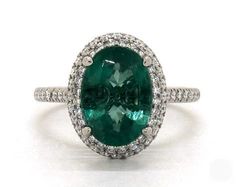 an oval cut emerald and diamond ring