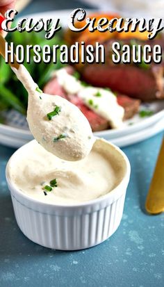 a spoon full of horseradish sauce sitting on top of a white dish with steak in the background