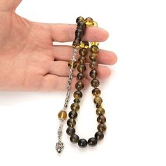 Unique and one-of-a-kind Islamic rosary beads, made of genuine Baltic amber. In amber visible inclusions of ancient nature and fauna which more than 40 million years. Collectible original rosary beads. The tasbih is carved from genuine amber stones. Amber tasbih are assembled on a high quality thread with a unique tassel of individual design, handmade. The rosary looks flawless and will be a wonderful accessory that conveys the natural energy and warmth of amber. Tasbih gives an incredibly pleasant feeling. This special Islamic rosary will make a wonderful gift for you and your loved ones. Weight rosary: 35 g Size Amber Beads: 0,43 in(11mm)  Imam size: 1,4 in(35 mm) Length rosary with imam: 9 in(23 cm) Looking for a Meaningful Gift - this is an excellent choice! For a gift for the love of Spiritual Amber Beads For Jewelry Making, Round Amber Beads Gems And Cabochons For Gifts, Round Amber Beads, Gems, And Cabochons For Gifts, Round Amber Beads And Cabochons For Gifts, Amber Beads And Cabochons For Gift, Amber Spiritual Round Beads, The Rosary, Natural Amber, Rosary Beads