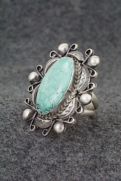 This turquoise and sterling silver ring was made by Navajo silversmith Wilson Dawes. The back is signed WD and stamped Sterling.Size: 9Length: 1 5/8"Width: 1 3/8"Free shipping on all orders! We ship with USPS and always include tracking. All orders ship within a day of payment.Returns are accepted up to 30 days after you receive your order. Just send us a message. Our shop offers cash back or store credit. The item must be returned in new condition. Turquoise Sterling Silver, Sterling Silver Ring, Silver Ring, Sterling Silver Rings, Silver Rings, Turquoise, Sterling Silver, Ring, Free Shipping