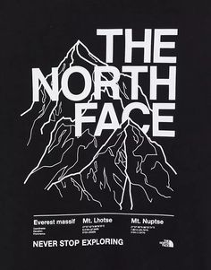 the north face logo on a black t - shirt with mountains in the back ground