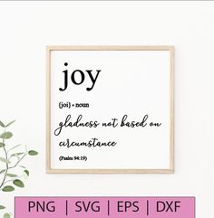 a framed print with the words joy on it next to a potted plant in front of a white wall