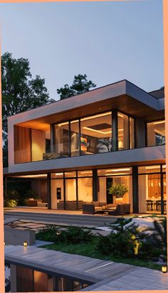 an image of a house that is lit up in the evening time with lights on