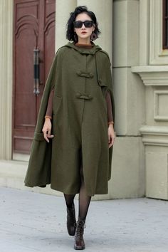 Crafted with the utmost attention to detail, this versatile cape exudes elegance and warmth. The military green color complements any outfit, making it suitable for both casual outings and formal occasions. DESIGN FEATURES * 30% Wool blend, 70% fiber nylon * Polyester lining * Double breasted buttons * Two side pockets * Hooded wool cape * Loose fit cape * Mid-calf length effect * Autumn winter cape coat * Dry Clean or Hand Wash in Cold Water MODEL SIZE Bust 85 cm(33.4") Waist 67 cm(26.7") Heigh Winter Cape Coat, Mantel Cape, Coat Cape, Winter Cape, Oversize Coat, Green Wool Coat, Water Model, Wool Winter Coat, Coat Autumn