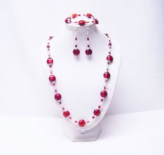 "Deep Red Flat Round Disc Foil Lined Glass Beads Necklace/Bracelet/Earrings This necklace set is made with 12mm red foil lined flat round disc lamp work glass beads, 6mm clear faceted glass beads, red glass beads, silver plated bead caps and silver plated spacer beads strung on flexible beading wire. It is 24\" in length and fastens with silver barrel clasp. It comes with bracelet and earrings that hang from silver fish hook ear wires. Necklace Length: 24\" Earrings Length: 2 ½\" (including ear Glass Beads Necklace, Red Foil, Red Flats, Silver Fish, Beading Wire, Bead Stringing, Wire Bracelet, Glass Bead Necklace, Faceted Glass