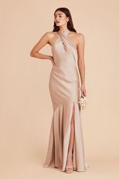 a woman in a nude colored gown with high slits and an asymmetrical neckline