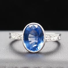 Year: 1920s Item Details: Ring Size: 5.25 Metal Type: Platinum   [Hallmarked, and Tested] Weight:  3.2 grams Sapphire Details: GIA Report #5212416100 Weight: 2.42ct Measurement: 9.83mm x 7.56mm x 3.79mm Type: Natural Sapphire, Unheated, Blue Color Side Stone Details: .20ct, total weight. Old European brilliant, natural diamond. Band Width:  1.75mm Condition:  Excellent Sapphire Engagement Ring, Sapphire Engagement, Diamond Band, Natural Sapphire, Engagement Rings Sapphire, Ring Verlobung, Types Of Metal, Natural Diamonds, Platinum