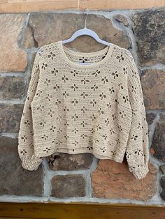 a sweater hanging on a brick wall