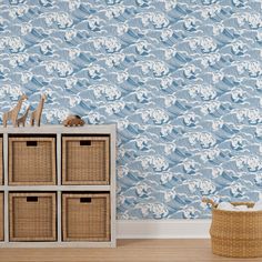 a blue and white wallpaper with waves in the background is next to a wicker basket