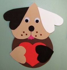 a paper cut out of a dog with a heart on it's chest hanging from a hook