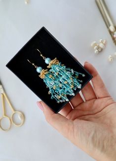 Discover the beauty of these handcrafted blue and gold seed bead earrings, accentuated with a sparkling zircon stone. Expertly made with attention to detail, these earrings offer a blend of elegance and charm, ideal for any occasion. The intricate design showcases vibrant colors that enhance their appeal, ensuring they complement both casual and formal attire with grace. Each pair is crafted uniquely, guaranteeing both quality and individuality. Treat yourself or a loved one to these exquisite e Turquoise Gemstone Beads Earrings As Gift, Gold Beaded Earrings With Faceted Beads For Gifts, Elegant Turquoise Beaded Earrings With Gold Beads, Elegant Earrings With Colorful Beads For Gift, Elegant Blue Faceted Beads Earrings, Elegant Turquoise Chandelier Earrings With Round Beads, Elegant Turquoise Chandelier Earrings, Crystal Beaded Earrings With Faceted Beads For Gift, Faceted Crystal Beaded Earrings For Gifts