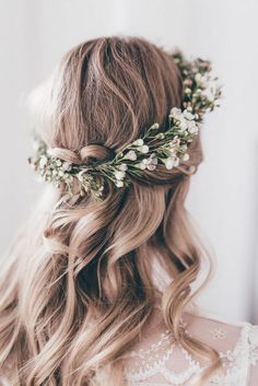 a woman with long hair wearing a flower crown