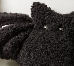 two black stuffed animals sitting next to each other