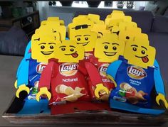 some legos are sitting on a table with chips in the shape of people's faces